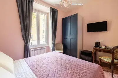 a bedroom with a bed and a window at Queen Meg Roma in Rome