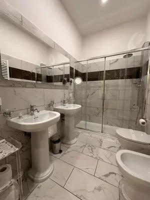 a bathroom with two sinks and a shower at Queen Meg Roma in Rome