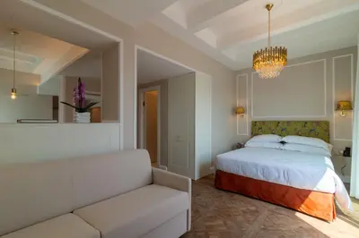 a hotel room with two beds and a window at Best Western Hotel Rivoli in Rome