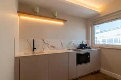 a hotel room with two beds and a desk at Best Western Hotel Rivoli in Rome