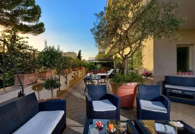 a dining room with a table and chairs and a chandelier at Best Western Hotel Rivoli in Rome