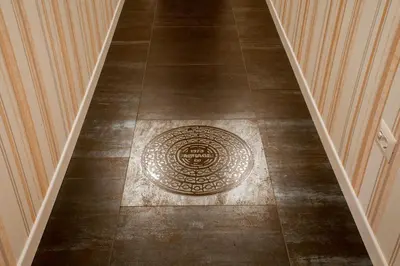 a tile floor with a drain in the middle of a hallway at Rome Visits in Rome