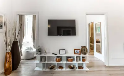 a living room with a white shelf with food on it at Thebestinrome Piazza di Spagna in Rome
