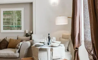 a living room with a table and a couch at Thebestinrome Piazza di Spagna in Rome