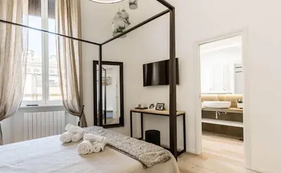 a bedroom with a bed with towels on it at Thebestinrome Piazza di Spagna in Rome
