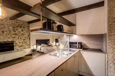 a kitchen with white cabinets and a sink at Trinità dei Monti Suite in Rome