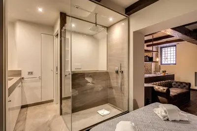 a bathroom with a shower with a glass door at Trinità dei Monti Suite in Rome