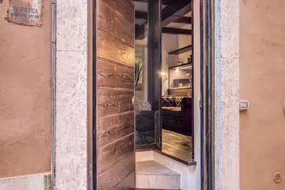 a sliding glass door with a reflection of a bedroom at Trinità dei Monti Suite in Rome
