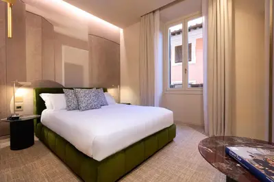 a hotel room with a bed and a window at Borghese Contemporary Hotel in Rome