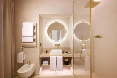 a bathroom with a shower and a sink and a mirror at Borghese Contemporary Hotel in Rome