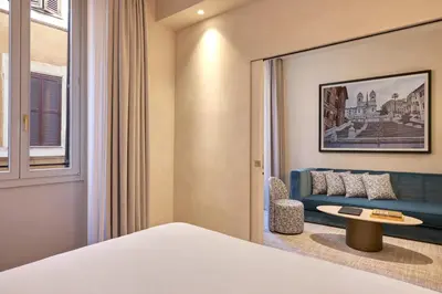 a hotel room with a bed and a couch at Borghese Contemporary Hotel in Rome