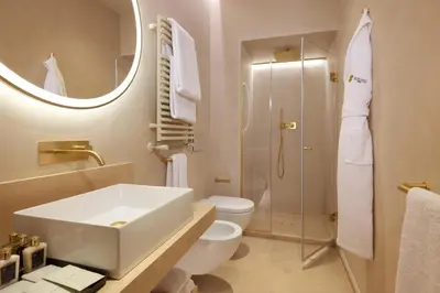 a bathroom with a sink and a toilet and a mirror at Borghese Contemporary Hotel in Rome