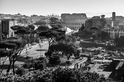 a black and white photo of a city with trees at La Cupola del Vaticano in Rome