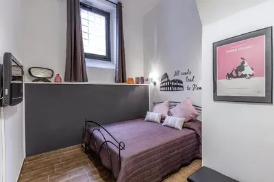 a small bedroom with a bed in a room at Del Falco Boutique Rooms San Pietro in Rome