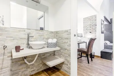 a bathroom with a sink and a mirror at Del Falco Boutique Rooms San Pietro in Rome