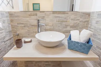 a bathroom with a bowl sink on a counter at Del Falco Boutique Rooms San Pietro in Rome