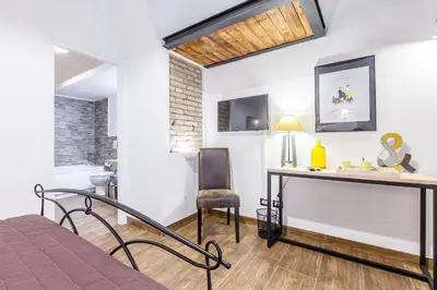 a bedroom with a desk and a chair in a room at Del Falco Boutique Rooms San Pietro in Rome