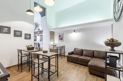 a living room with a couch and a table at Del Falco Boutique Rooms San Pietro in Rome