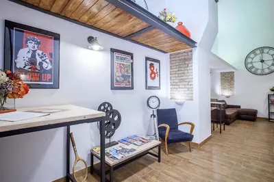 a living room with a table and a couch at Del Falco Boutique Rooms San Pietro in Rome
