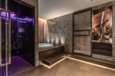 a bathroom with a tub and a shower with purple lighting at Eitch Borromini Palazzo Pamphilj in Rome