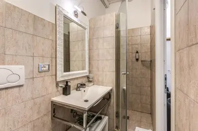 a bathroom with a sink and a shower at Magenta Deluxe Cancello in Rome