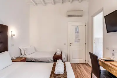a small room with a bed and a desk at Magenta Deluxe Cancello in Rome