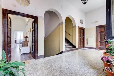 an open hallway with arches and a staircase in a home at Living Rome Repubblica apartment in Rome