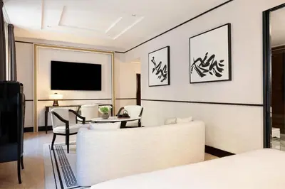 a hotel room with a bed and a table and a tv at Nobu Hotel Roma in Rome