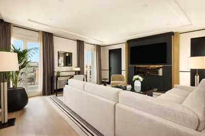 a living room with a large couch and a tv at Nobu Hotel Roma in Rome