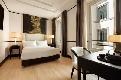 a hotel room with a bed and a desk at Nobu Hotel Roma in Rome