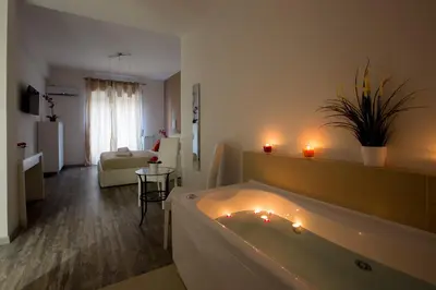 a bathroom with a bath tub with candles in it at Luxury House Vaticano in Rome