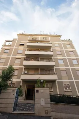 a tall tan building with a lot of windows at Luxury House Vaticano in Rome