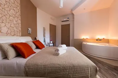 a bedroom with a large bed and a bath tub at Luxury House Vaticano in Rome