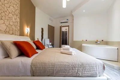 a bedroom with a large bed and a bath tub at Luxury House Vaticano in Rome
