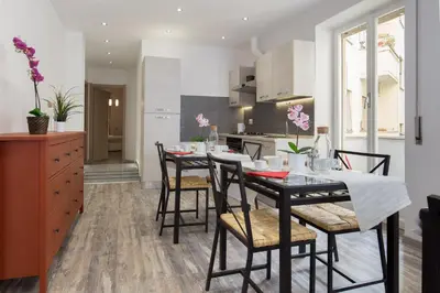 a kitchen and dining room with a table and chairs at Luxury House Vaticano in Rome