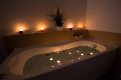 a large bath tub with candles in a bathroom at Luxury House Vaticano in Rome