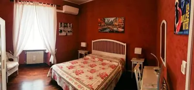 a red bedroom with a bed and a window at CiaoRoma! in Rome