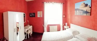 a red bedroom with a bed and a window at CiaoRoma! in Rome