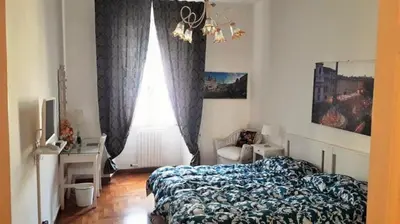 a bedroom with a bed and a desk and a window at CiaoRoma! in Rome