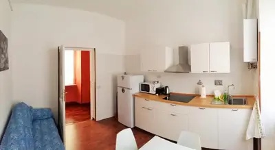 a kitchen with a refrigerator and a counter top at CiaoRoma! in Rome
