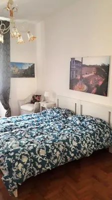 a bedroom with a bed with a blue and white blanket at CiaoRoma! in Rome