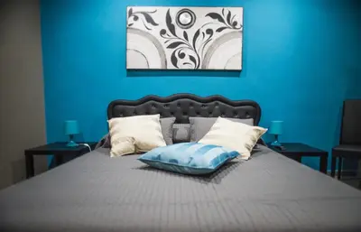 a blue bedroom with a bed with a blue wall at Costantino Secondo Guest House in Rome
