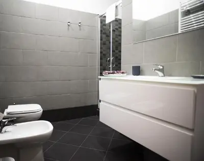 a white bathroom with a sink and a toilet at Costantino Secondo Guest House in Rome