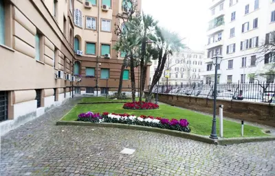a courtyard in a city with flowers and buildings at Costantino Secondo Guest House in Rome