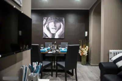 a dining room with a black table and chairs at Costantino Secondo Guest House in Rome