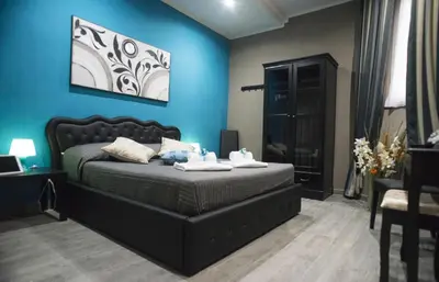 a bedroom with a bed and a blue wall at Costantino Secondo Guest House in Rome