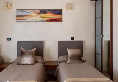 a bedroom with a bed and a desk with a lamp at New Joyful Guest House in Rome