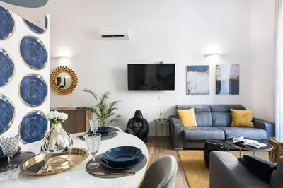 a living room with a couch and a table at Vatican Imperial Apartment 2840sq ft in Rome
