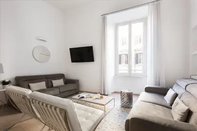 a living room with a couch and a table at Vatican Imperial Apartment 2840sq ft in Rome