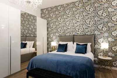 a bedroom with a large bed with a blue blanket at Vatican Imperial Apartment 2840sq ft in Rome